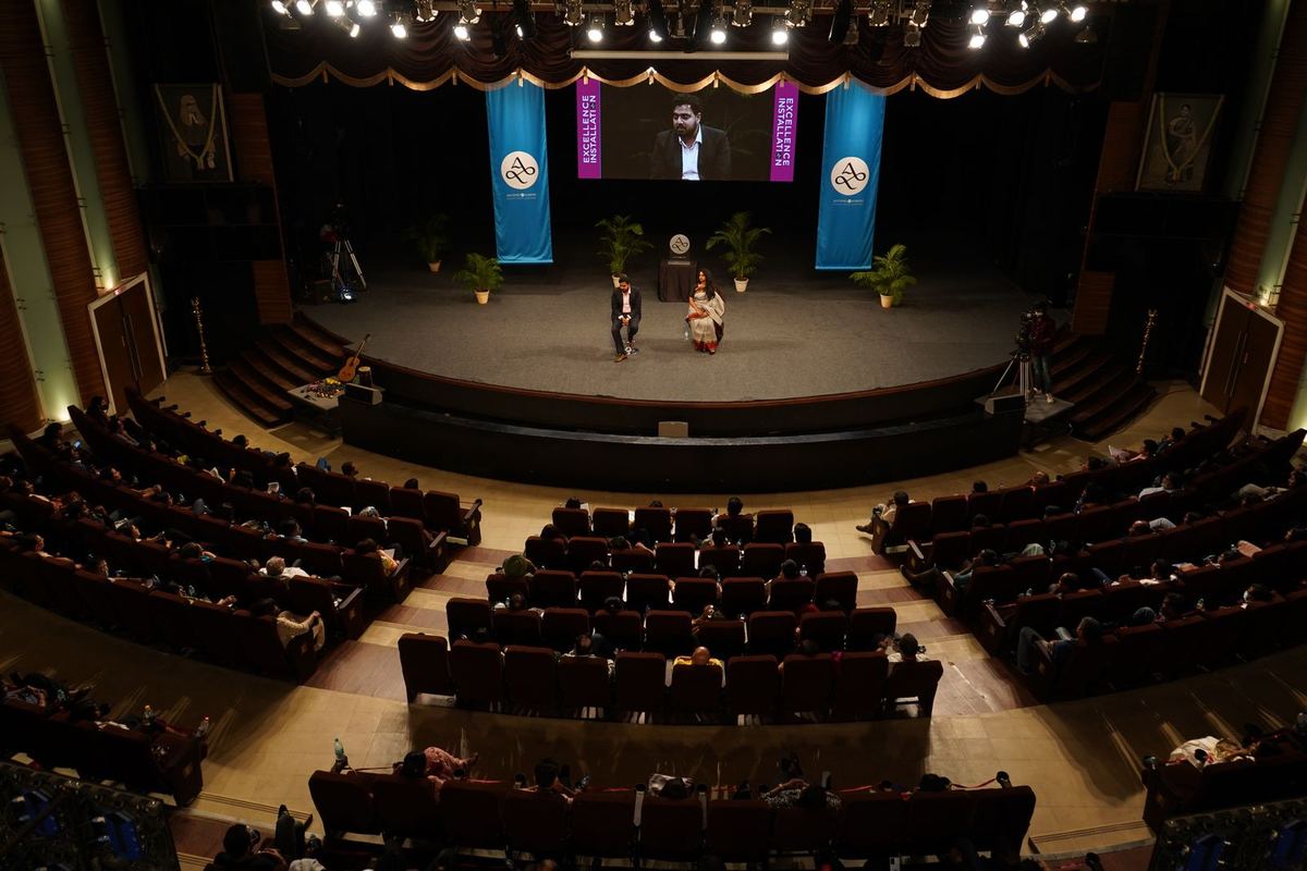 The auditorium from the balcony, Antano and Harini on stage