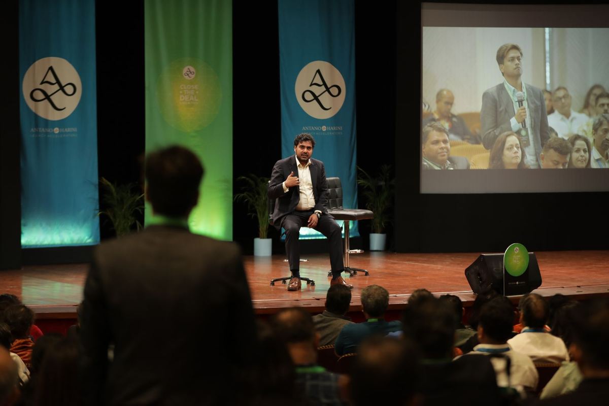 Antano on stage, the room watching from the rear