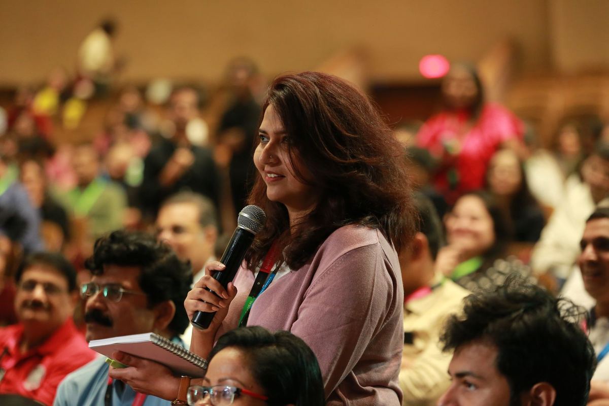 A participant asking a question on the microphone