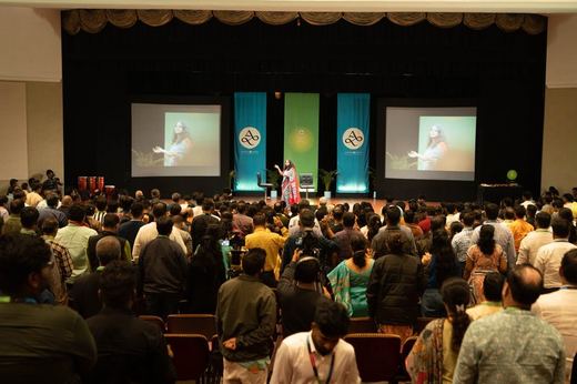 Harini on stage before a standing hall